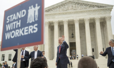 Photo of the victors in the Janus Case walking out of the U.S. Supreme Court building