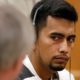 Photo of Cristhian Bahena Rivera speaking with his attorney