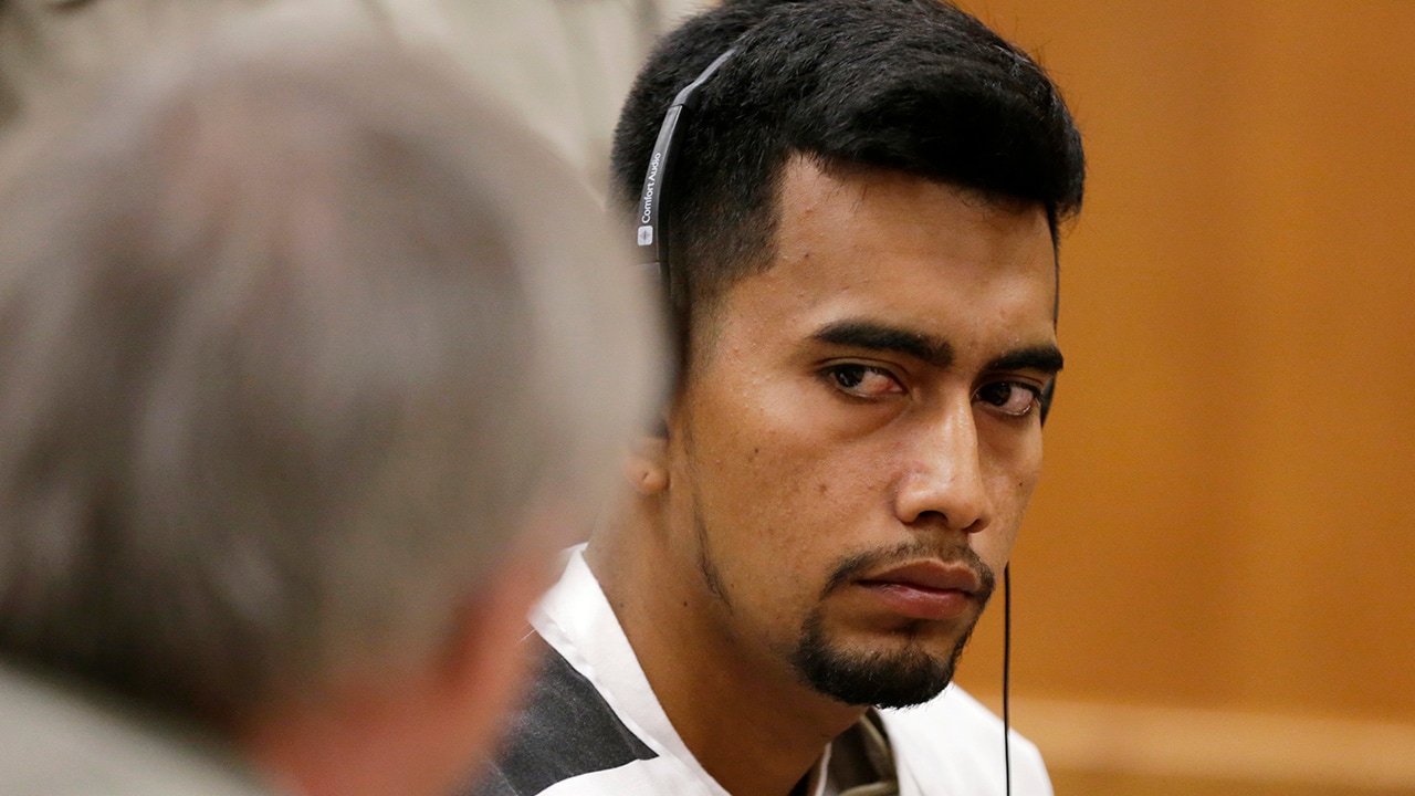 Photo of Cristhian Bahena Rivera speaking with his attorney
