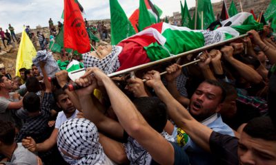 Photo of mourners carrying the dead body of Palestinian teen Nadim Nuwara