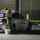 Photo of Kern County sheriff's deputy stands near an area where a shooting victim lies