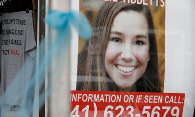 Photo of missing Mollie Tibbets poster hanging in a store window