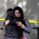 Photo of mourners embracing outside the Thousand Oaks Teen Center