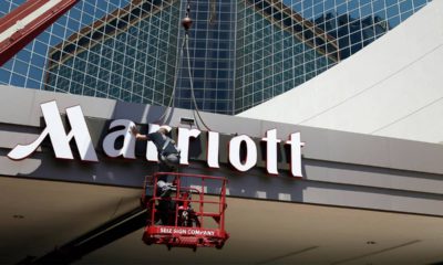 Photo of man working on a Marriott hotel sign
