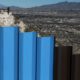Photo of border fence and border patrol agent in New Mexico