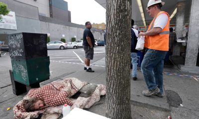 Photo of a man sleeping on the sidewalk in Seattle, WA