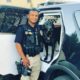 Photo of Newman, California, police officer Ronil Singh standing next to his patrol car