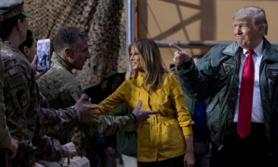 Photo of President Donald Trump and Melania Trump getting US troops in Iraq