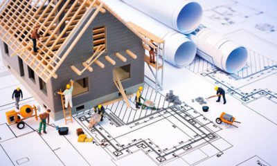Photo of miniature house and blueprints.