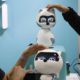 Photo of people touching Kiki robots