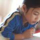 Photo of Asian American girl reading