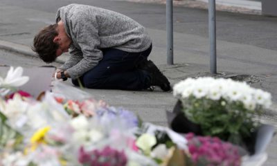 Photo of mourner praying near Linwood mosque