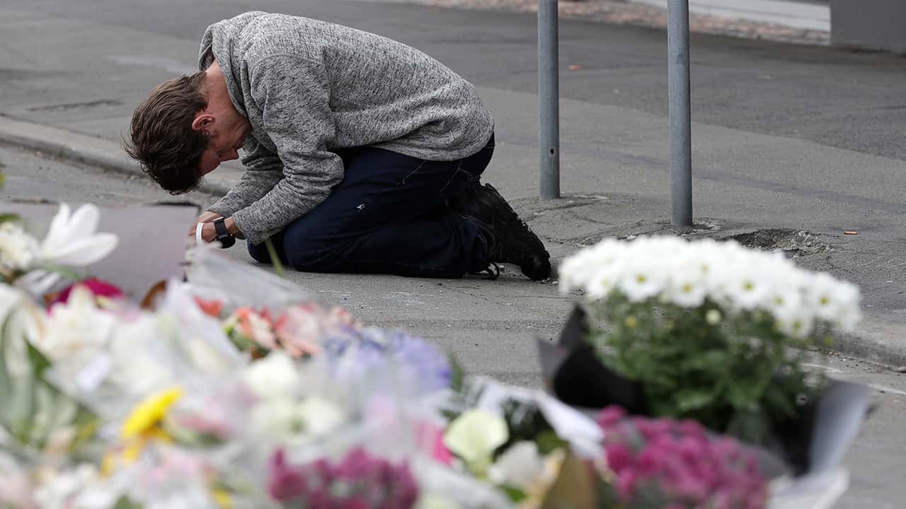 Photo of mourner praying near Linwood mosque