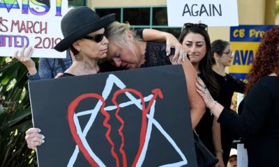 Leslie Gollub, left, and Gretchen Gordon hug at a vigil held to support the victims of the Chabad of Poway synagogue