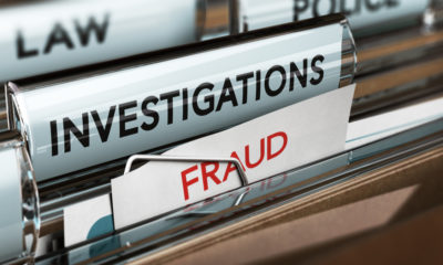 Photo of files marked fraud, investigations and law