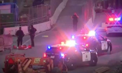 Screenshot of police officers and border agents at the California-Mexico border