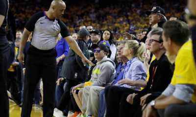 Photo of referee Marc Davis gestures toward Warrior investor Mark Stevens