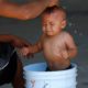 Photo of a baby getting a bath at a migrant shelter in Mexico