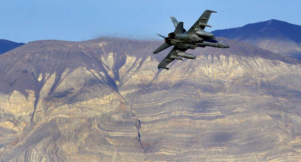 Photo of a U.S. Navy F-18 Super Hornet flying out of Star Wars Canyon in Death Valley, California.
