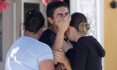 Photo of Joshua Guicho, 16, center, crying between his aunts Josephine Guicho, left, and Erica Guicho