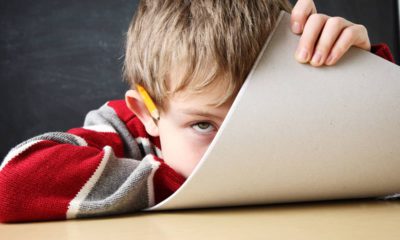 Photo of a bored student hiding his face