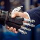 Photo of a robot shaking hands with a businessman