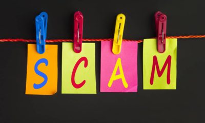 The letters s c a m hanging from a clotheslines signifying a scam