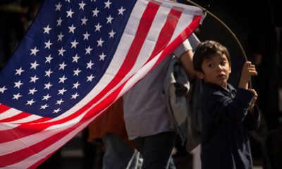Photo of a young boy holding an American flag