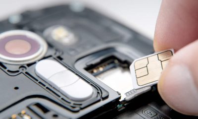 Photo of a SIM card and a cell phone