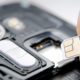 Photo of a SIM card and a cell phone