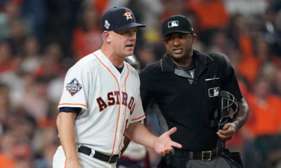 Photo of AJ Hinch arguing a call with an umpire