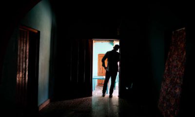 Photo of Honduran father standing at his home