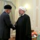 Photo of President Hassan Rouhani, right, shakes hands with Omani Minister of State for Foreign Affairs Yusuf bin Alawi
