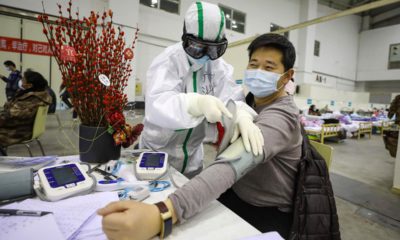 Photo of a medical staff member attends to a patient