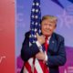 Photo of President Donald Trump hugging the American flag