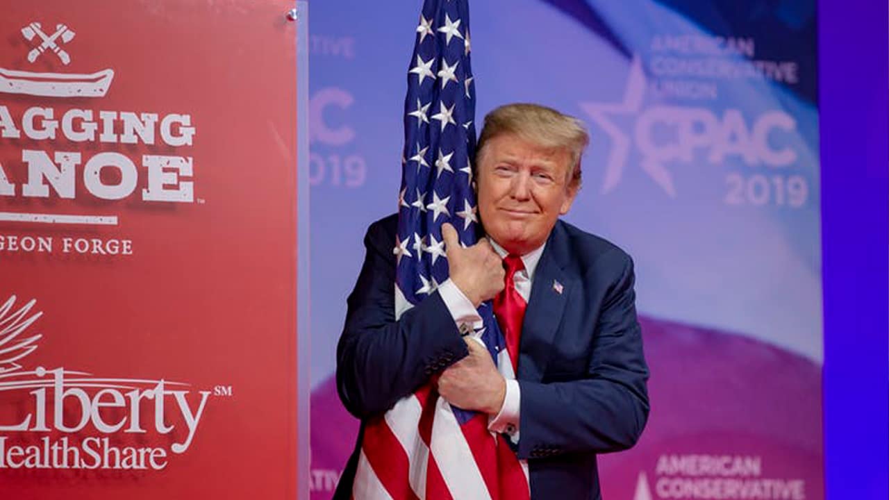 Photo of President Donald Trump hugging the American flag