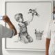 Photo of health care workers in front of a new artwork by Banksy