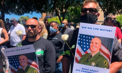 Photo of men holding posters of Sgt. Damon Gutzwiller