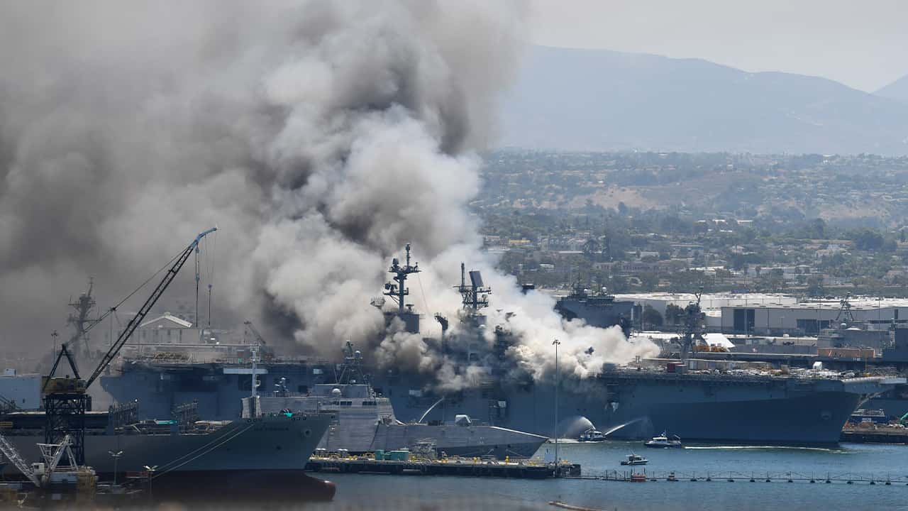 Photo of smoke rising from the USS Bonhomme Richard at Naval Base San Diego