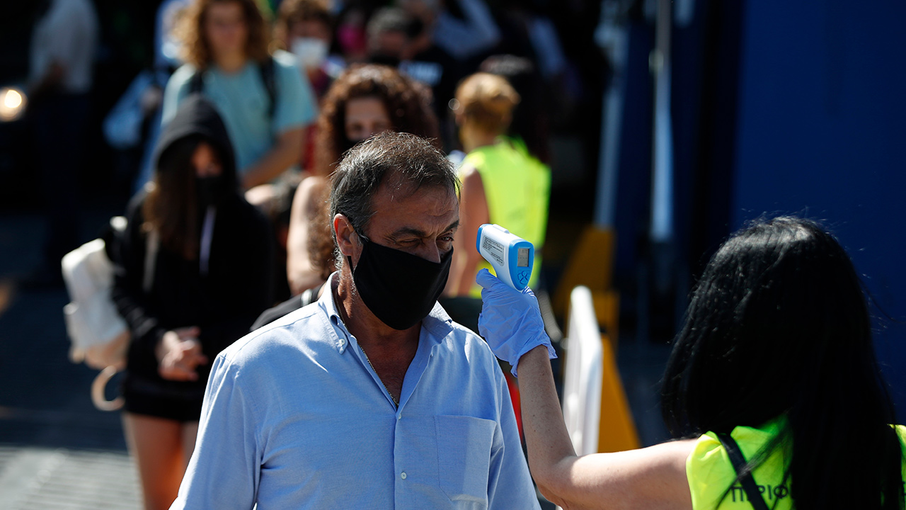Photo of workers taking temperatures